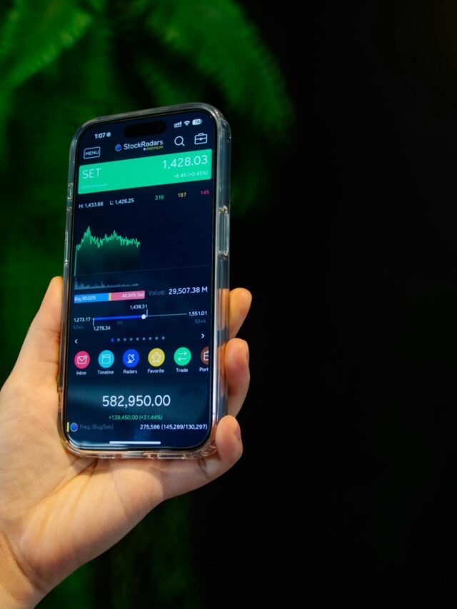 Close-up of a smartphone displaying a stock trading app with market data on-screen.